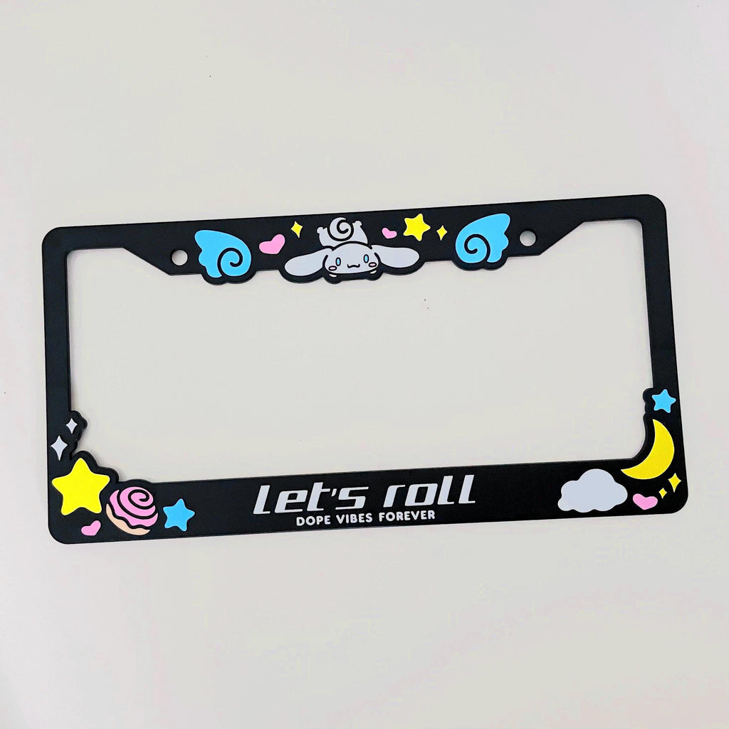 Black license plate frame with Cinnamoroll design with white text "Let's roll"