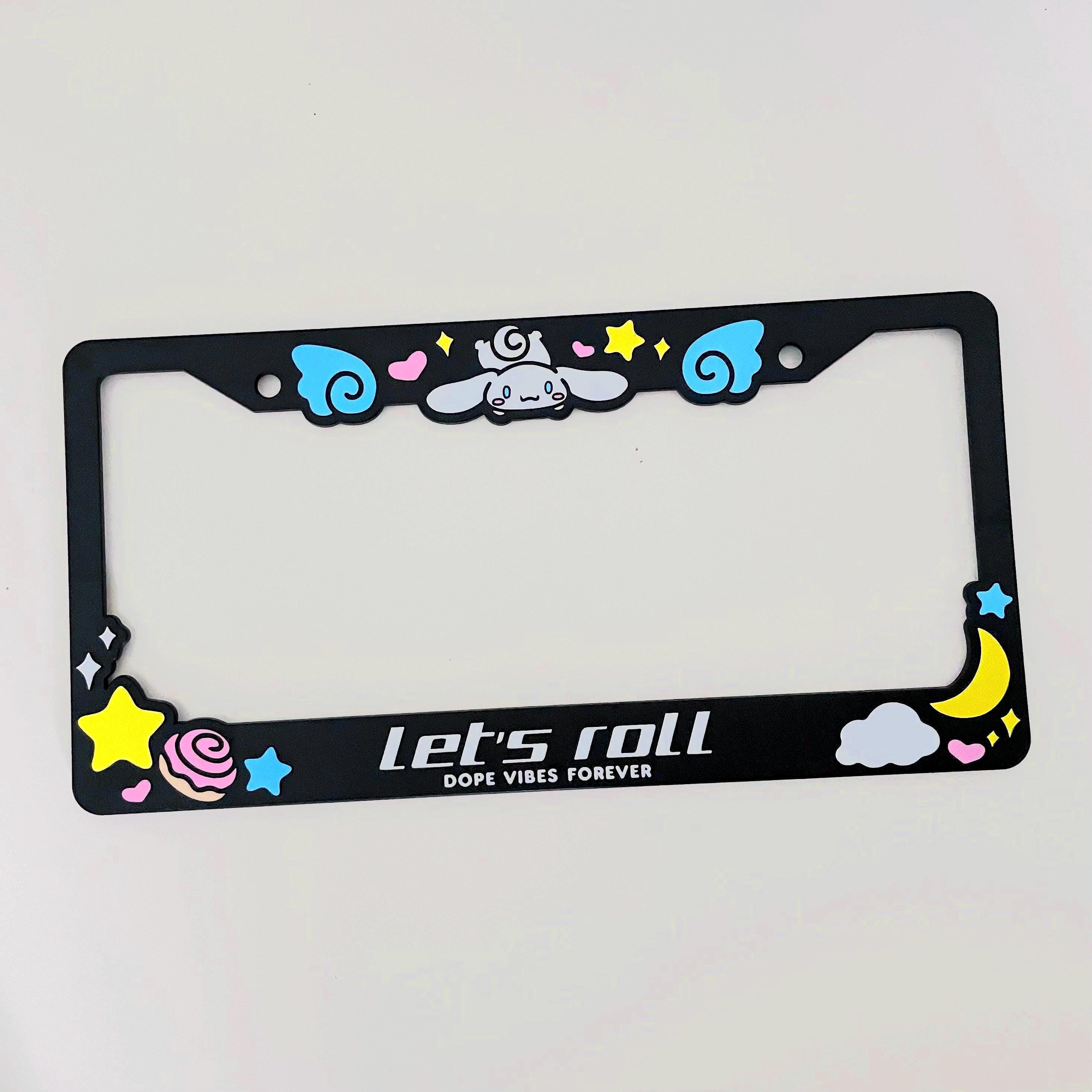 Black license plate frame with Cinnamoroll design with white text "Let's roll"