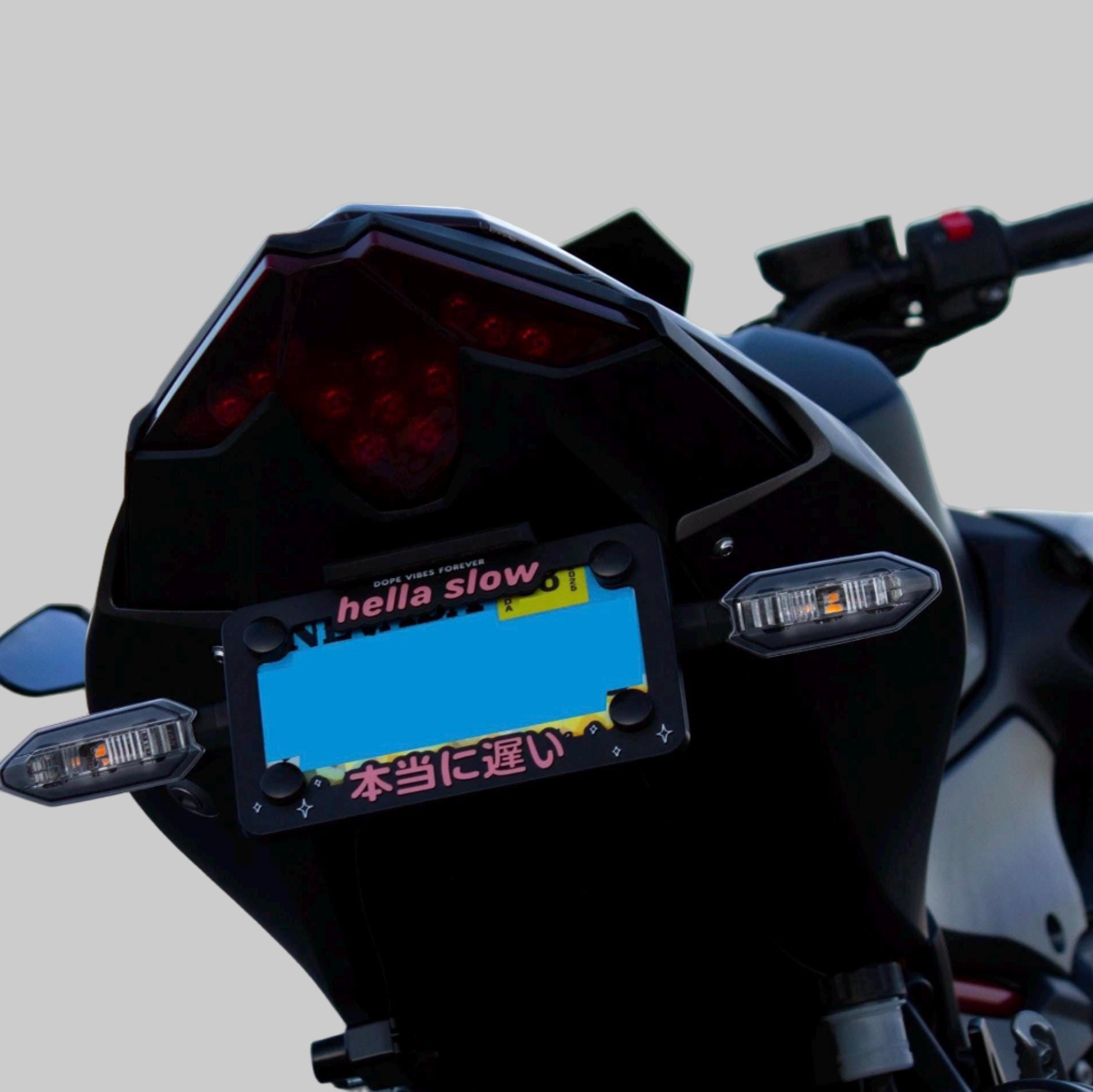 Hella slow text on motorcycle license plate frame