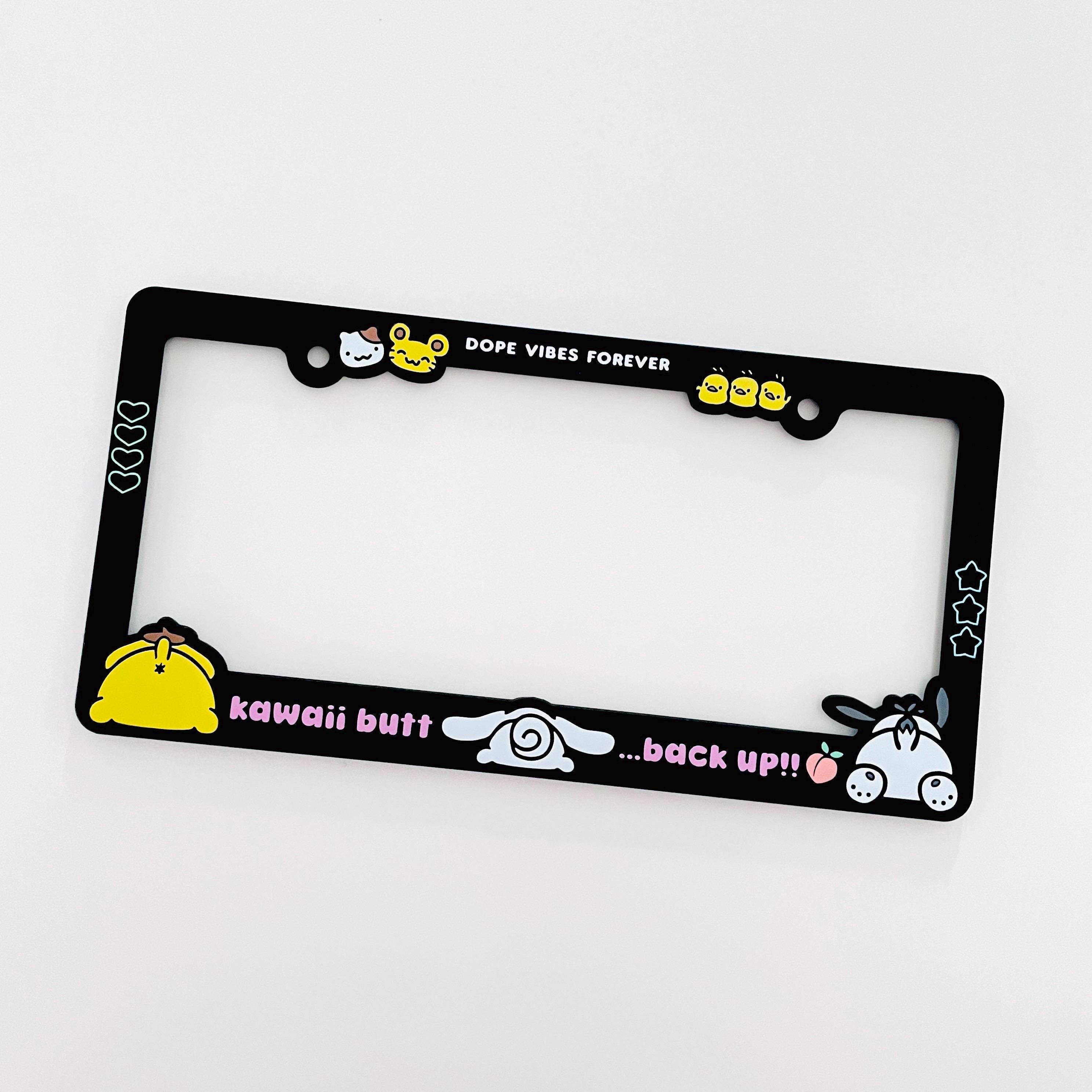 Black license plate frame with Cinnamoroll, PomPomPurin, and Pochacco designs. Text reads "Kawaii butt, back up!!"